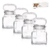 Four clear glass spice jars with silver lids are arranged in a row against a white background. A small box with product information is visible in the upper right corner. Náhľad obrázku produktu