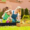 A mother and daughter are gardening together in a backyard. Produktbild-Vorschau