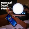 A person is holding a smartphone with a light control app open, in front of a large, glowing spherical lamp on a nightstand. The lamp is emitting a bright white light. Náhľad obrázku produktu