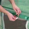 Hands are shown attaching a white tape to a green mesh material, which is rolled up. Anteprima dell’immagine prodotto