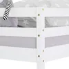 A close-up view of a white wooden bunk bed frame with bedding. Produktbild-Vorschau