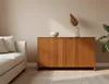 A living room scene with a sofa and a wooden cabinet. Produktbild-Vorschau
