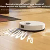 A white robot vacuum cleaner is shown on a wooden floor, with dust and debris being sucked up. Text overlays highlight its suction power. Náhľad obrázku produktu