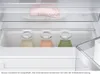 Interior view of a refrigerator drawer with bottles of liquid. Produktbild-Vorschau