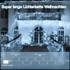 A house decorated with white Christmas lights for the holidays. Produktbild-Vorschau