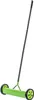A green manual lawn aerator with black wheels and handle, isolated on a white background. Produktbild-Vorschau