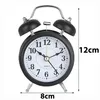 A black retro analog alarm clock with dimensions indicated by text overlays. Voir les images du produit
