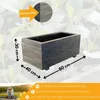 A wooden planter box with dimensions indicated, and a person in the background. Produktbild-Vorschau