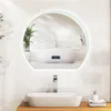 A modern bathroom with a sink, faucet, and a large round mirror reflecting a bathtub. Produktbild-Vorschau