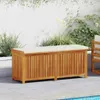 An outdoor storage bench with a cushion sits on a patio next to a pool. Náhled obrázku produktu