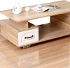 A close-up view of a modern coffee table with a drawer and a shelf, featuring a teapot, a cup, and a magazine on its surface. Náhled obrázku produktu