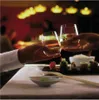 Two people toasting with wine glasses at a table with sushi. Produktbild-Vorschau