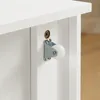 A close-up view of a white shelf with a small white caster wheel attached to the side. Náhľad obrázku produktu