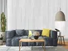 A living room scene with a sofa, coffee table, and decorative wall panels. Produktbild-Vorschau