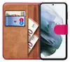 A book-style phone case with a card and banknotes inside, shown open with a smartphone in place. Anteprima dell’immagine prodotto