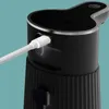 A close-up view of a black automatic soap dispenser being charged via a white USB-C cable. Anteprima dell’immagine prodotto