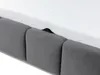 A close-up view of the edge of a mattress resting on a padded bed base. Náhled obrázku produktu
