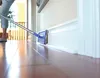 A person is cleaning the baseboard of a wall with a mop. Anteprima dell’immagine prodotto