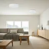 A modern living room with a sofa, coffee table, and a sideboard. Produktbild-Vorschau