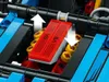 A close-up view of a LEGO Technic model engine with V8 markings. Anteprima dell’immagine prodotto