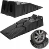 Two black plastic car ramps are shown, with one ramp in the foreground with a car wheel on it. Podgląd zdjęcia produktu