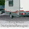 A caravan and a car parked on a gravel surface, with text overlay. Produktbild-Vorschau