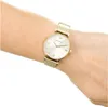 A close-up shot of a gold Emporio Armani watch on a person's wrist. Voir les images du produit
