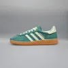 A single Adidas Handball Spezial shoe is shown against a plain gray background. Produktbild-Vorschau