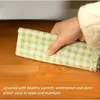 A hand wiping a wooden surface with a cloth. Náhled obrázku produktu