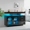 A modern black sideboard with LED lighting, displayed in a room setting with a plant and a telescope visible. Náhled obrázku produktu