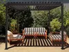 An outdoor seating area under a pergola with a sofa, chairs, and a small table. Produktbild-Vorschau