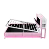 A pink upholstered bed frame with its mattress support mechanism lifted, revealing storage space underneath. The headboard has integrated shelving and a pink LED light strip. Produktbild-Vorschau