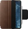 A brown leather case for an iPad Pro is shown with the screen displaying a blue and white abstract image. A white stylus is attached to the side of the case. Podgląd zdjęcia produktu