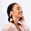 A woman with her eyes closed is wearing white and pink headphones and smiling. Produktbild-Vorschau