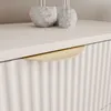 A close-up shot of a drawer handle on a fluted dresser. Produktbild-Vorschau