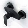 A black shower faucet mounted on a white wall with measurement lines. Produktbild-Vorschau