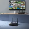 A split image showing a security camera system display on a TV in the top half, and a network video recorder (NVR) with antennas in the bottom half. Produktbild-Vorschau