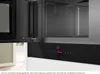 Close-up view of the interior and control panel of a black built-in microwave. Voir les images du produit