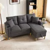A dark gray sectional sofa with a chaise lounge is shown in a living room setting. Podgląd zdjęcia produktu