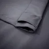 A close-up of the hem and grommet area of a dark gray outdoor curtain. Náhled obrázku produktu