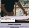 A person is working with a piece of material, possibly wool or fur, on a wooden surface. The brand logo and slogan are overlaid on the image. Produktbild-Vorschau