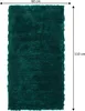 A green rug with dimensions indicated by measurement lines and text. Produktbild-Vorschau