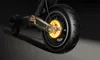 A close-up view of the rear wheel and motor of an electric scooter, with the internal components of the motor glowing orange. Produktbild-Vorschau