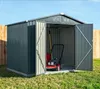 A metal garden shed with its doors open, showing a lawnmower and garden tools inside. The shed is set up on a grassy lawn with a wooden fence in the background and a clear blue sky above. Podgląd zdjęcia produktu