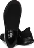 A pair of black Skechers slip-on shoes are shown from a top-down perspective against a white background. Voir les images du produit