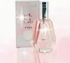 A perfume bottle and its box are displayed on a pink gradient background with sparkling effects. Produktbild-Vorschau