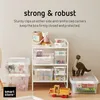 A collection of transparent storage boxes on a white shelf, with a toy dinosaur and a toy truck nearby. Produktbild-Vorschau