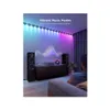 A living room scene with speakers and a TV stand, illuminated by colorful LED strip lights that sync with music. Anteprima dell’immagine prodotto
