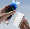 A person is holding a smartphone and a white wireless power bank, demonstrating magnetic charging. Náhľad obrázku produktu