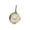 A frying pan with packaging and labels, presented on a white background. Produktbild-Vorschau